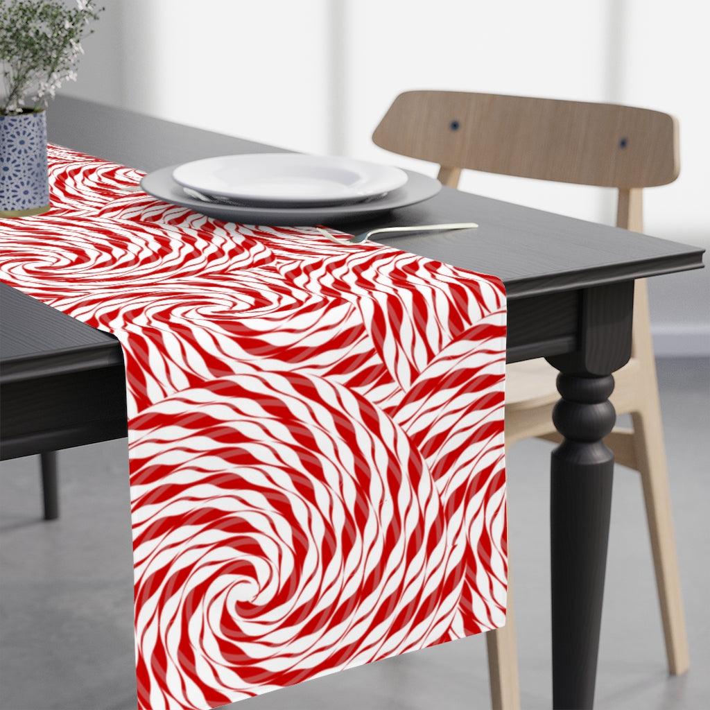 christmas candy decor featuring a red and white candy cane table runner