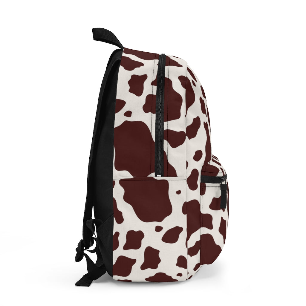 side view of womens or girls cow print backpack for back to school or travel