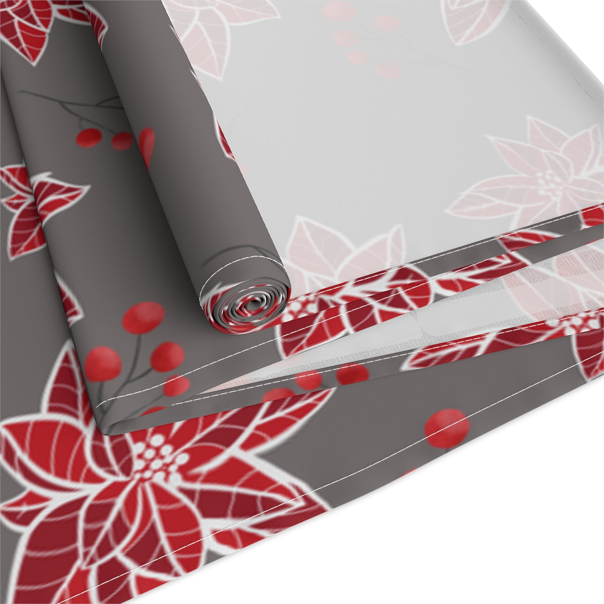 close up view of christmas table runner with poinsettias