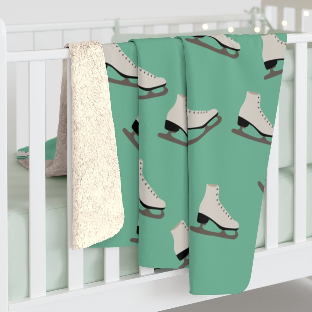 green figure skating blanket with white figure skates