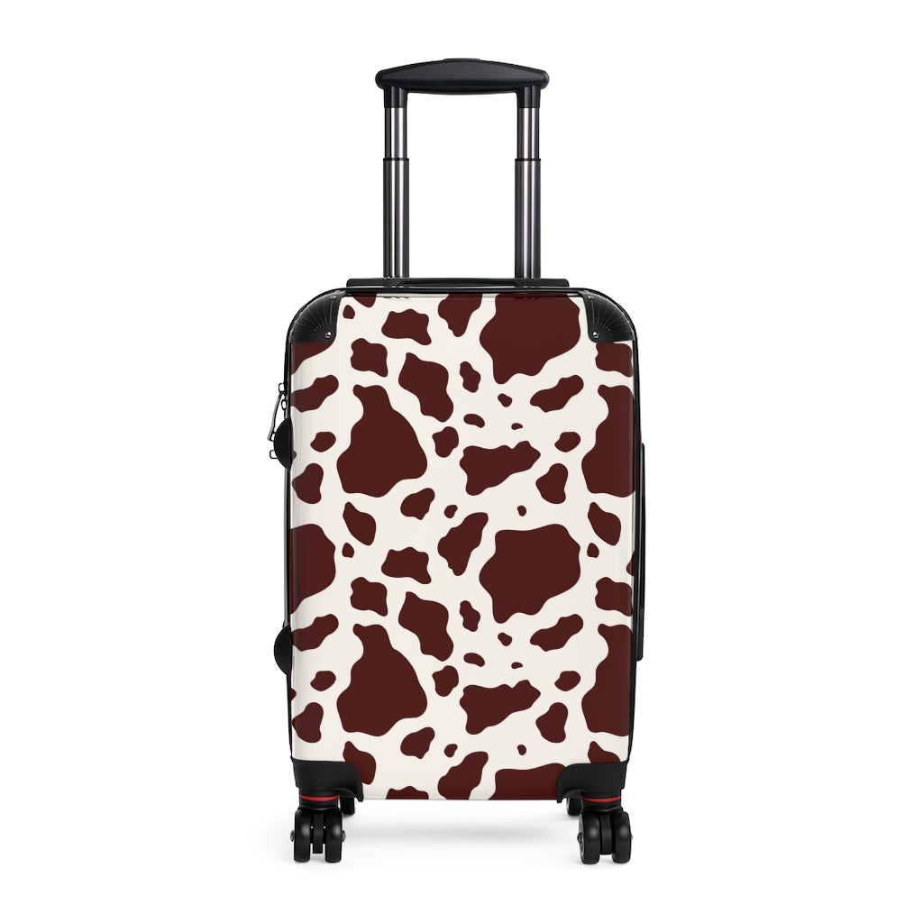 brown and white cow print luggage featuring a cabin suitcase