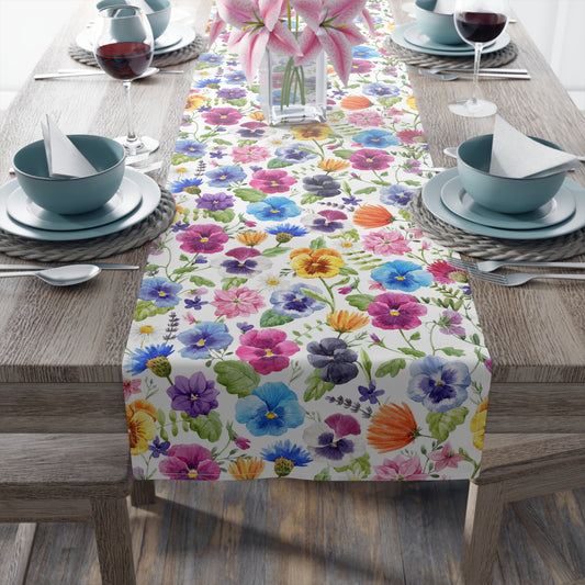 floral table runner with yellow, blue, orange, purple and white pansy print