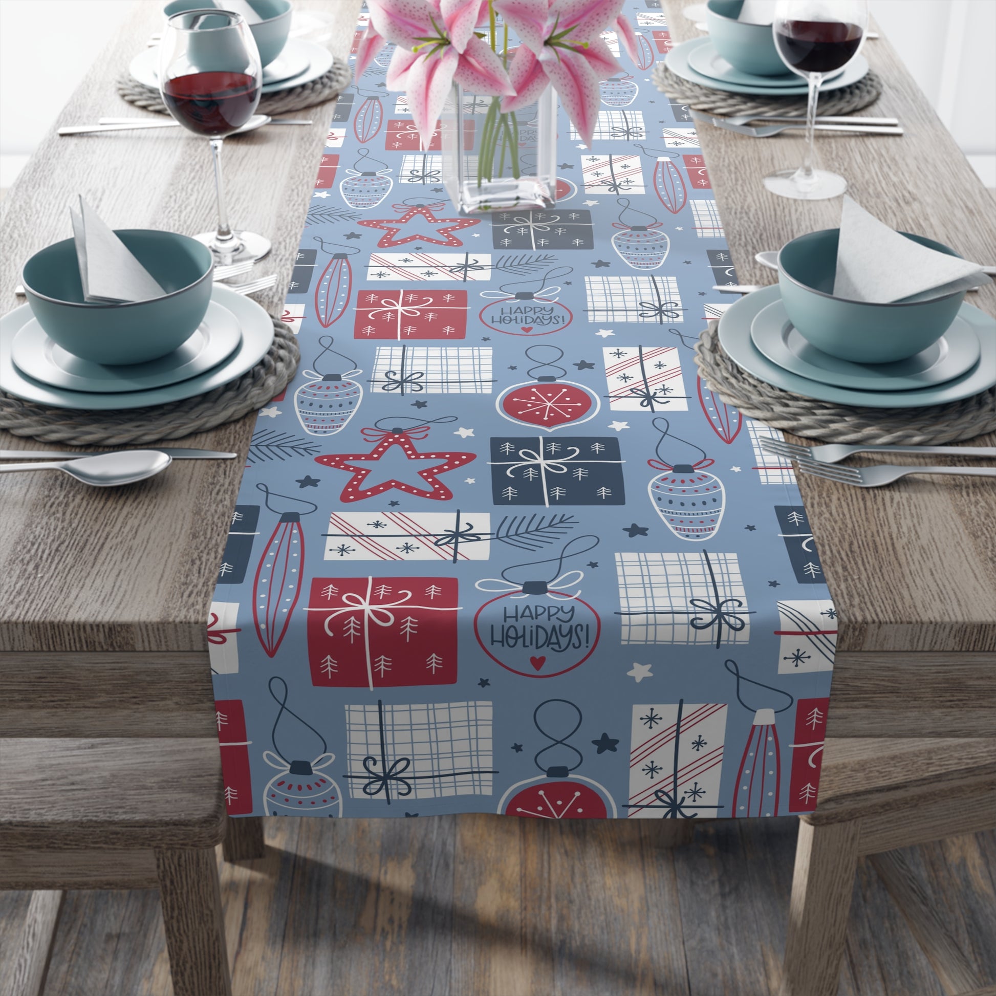 blue christmas table runner with christmas bulbs, lights, presents and star print in red, navy blue and white colors