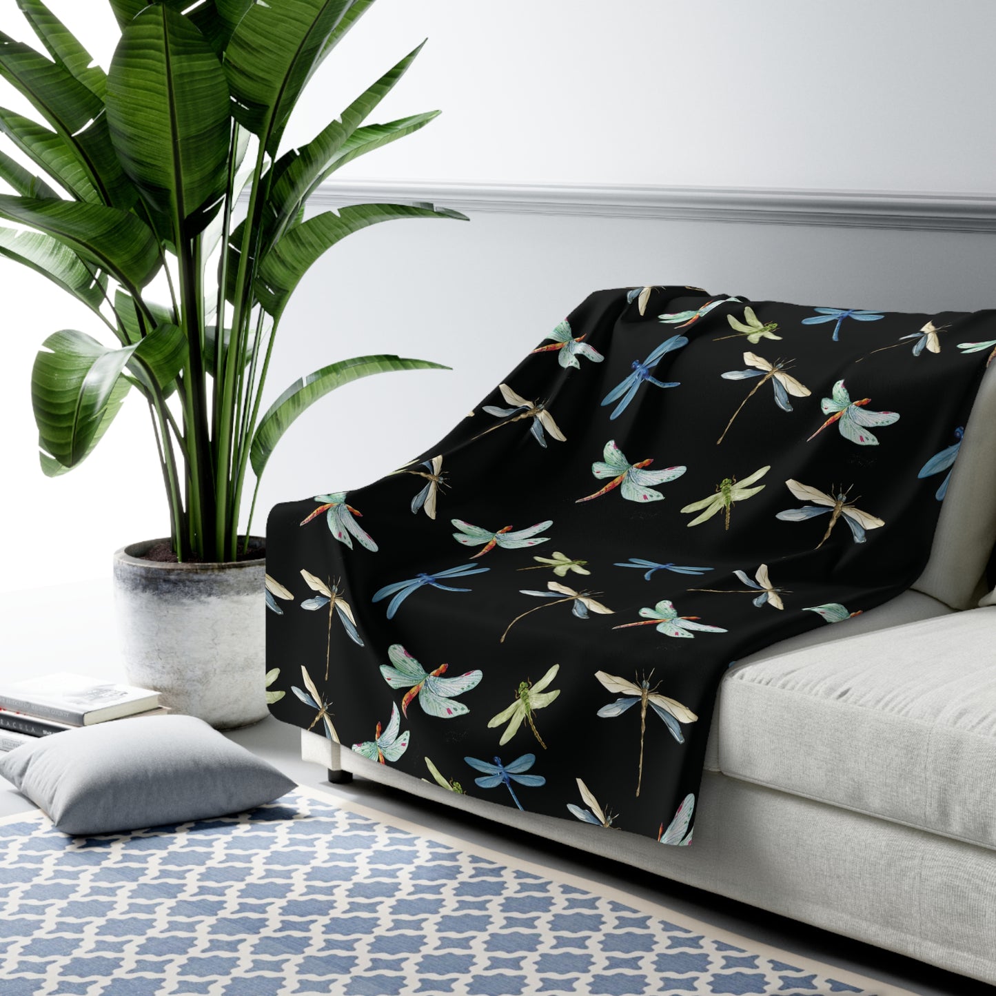 black sherpa blanket with blue, beige and green dragonfly print