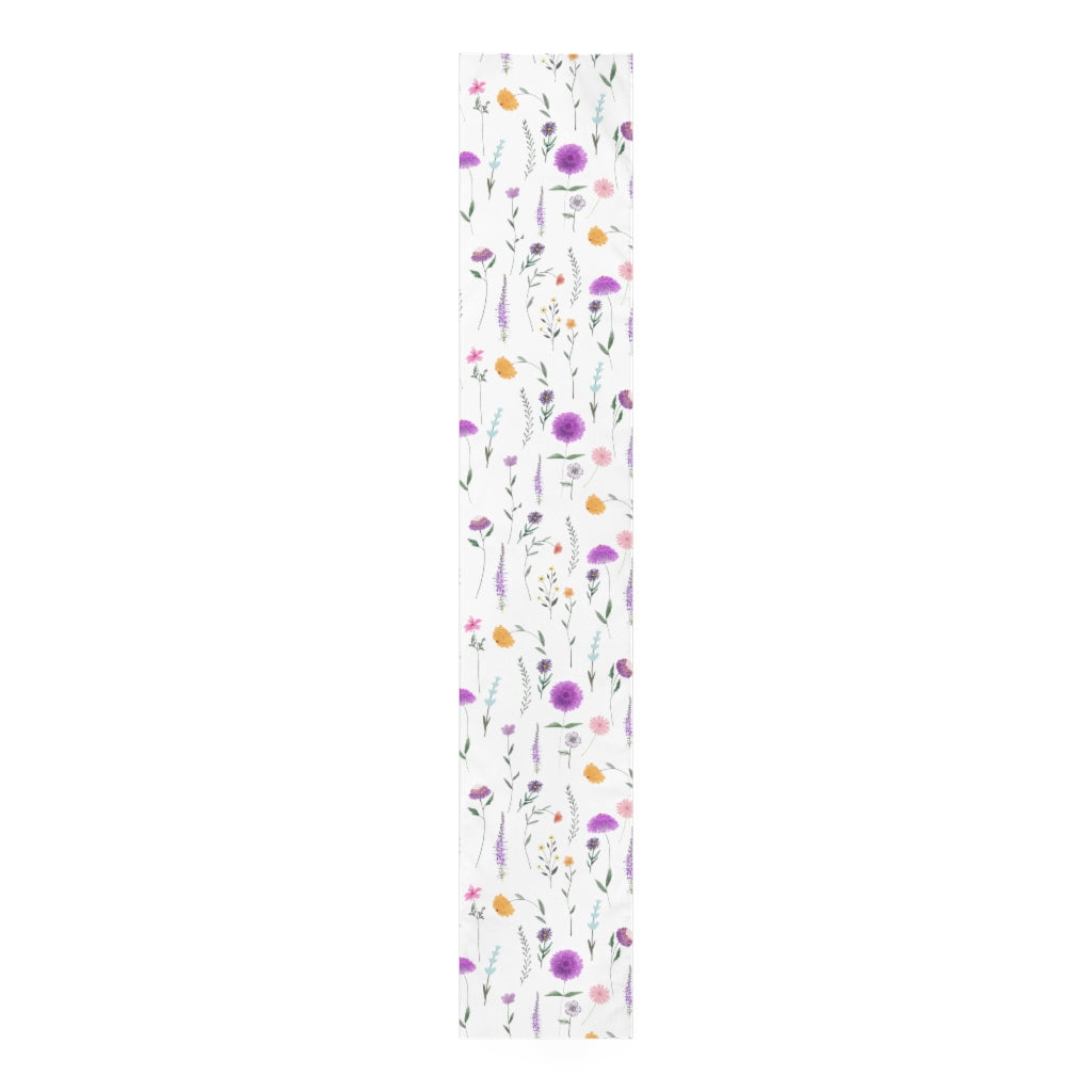 floral table runner in simple floral pattern with purple, pink and yellow flowers.