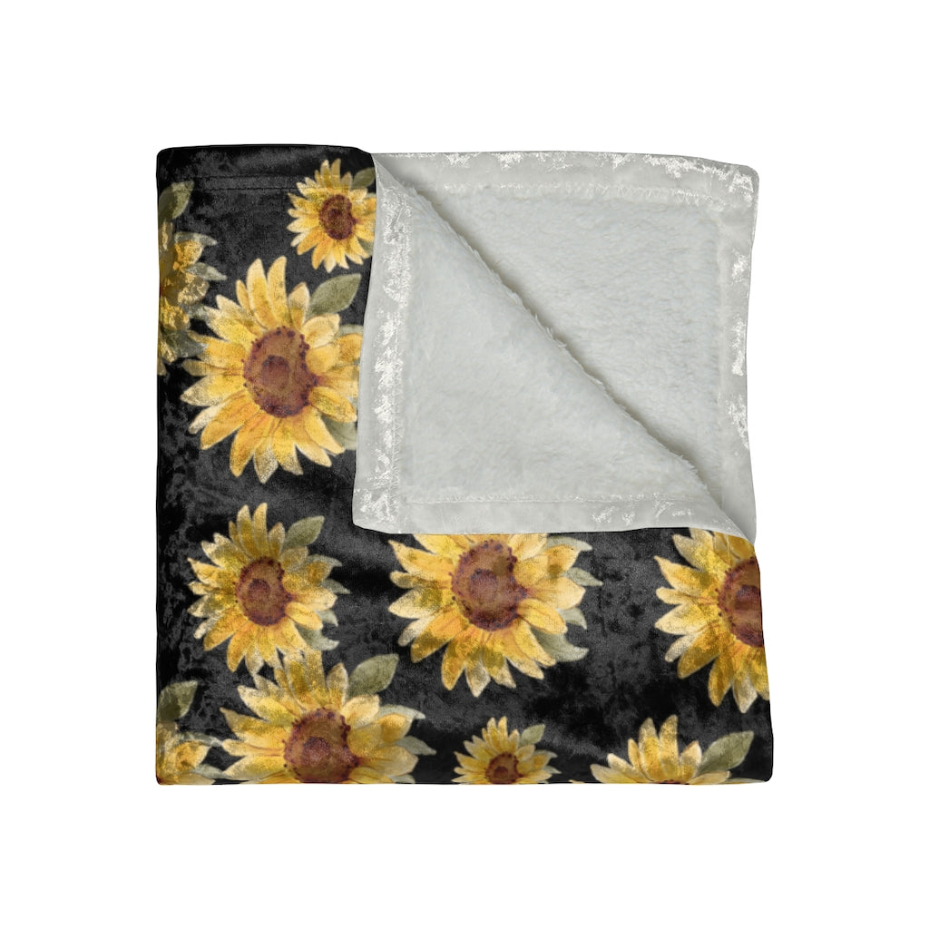 folded view of black velvet blanket with yellow sunflowers