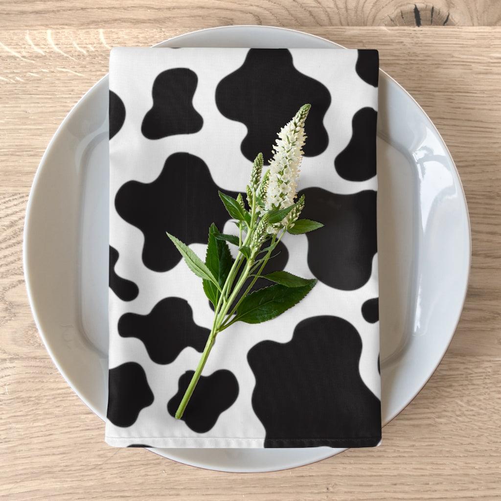 cow print farmhouse decor. cloth dinner napkins in animal print black and white