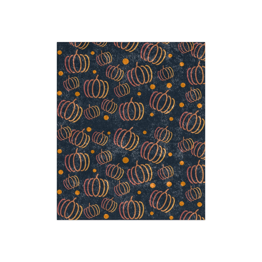 flat view of navy blue blanket with orange pumpkins and polkadots