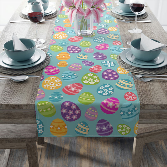 blue easter table runner with pink, purple, yellow easter egg pattern