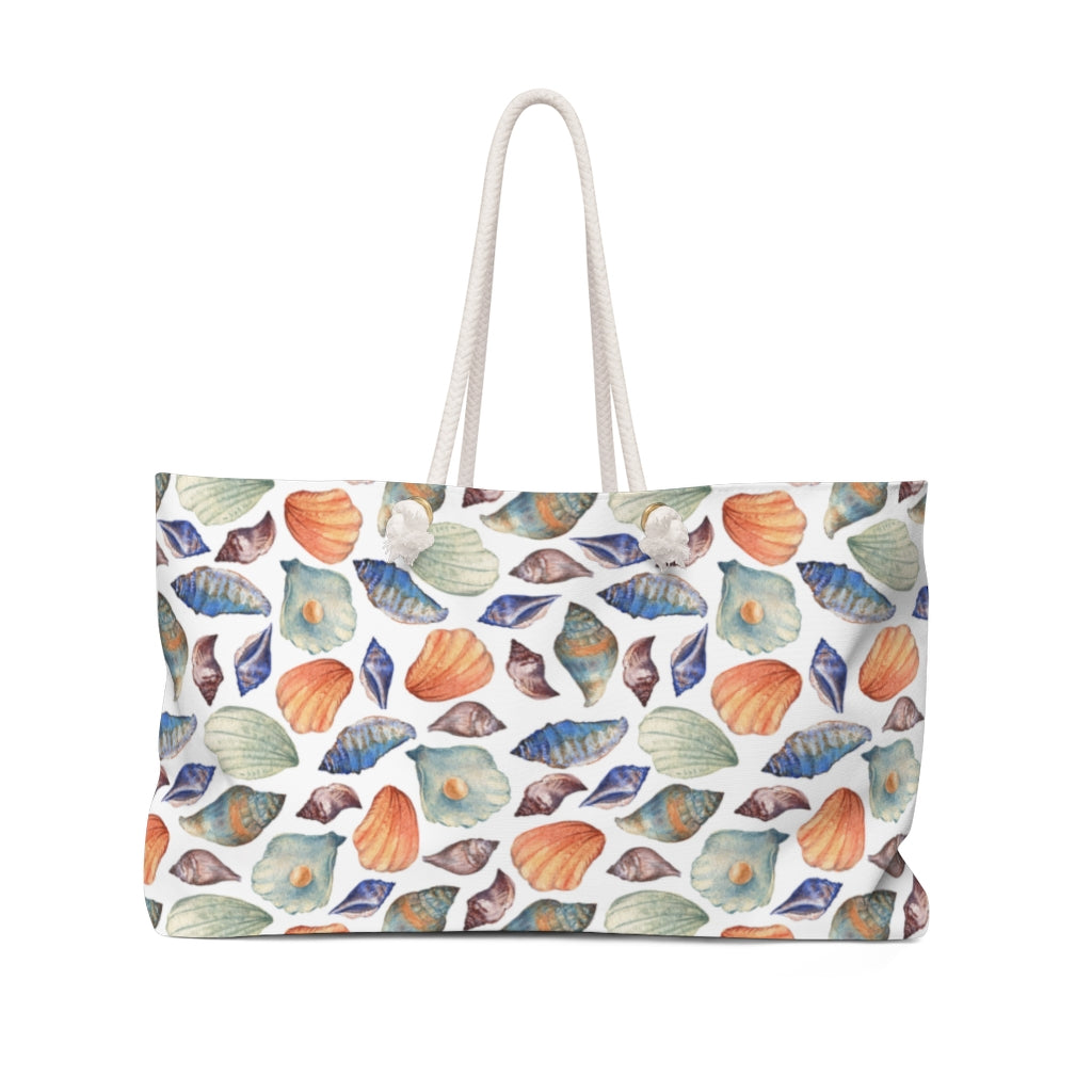 seashell weekender bag with blue, orange and purple sea shells 