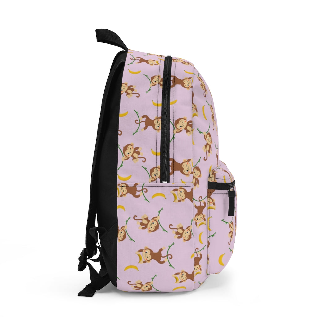 side view of pink bookbag with monkey and banana pattern
