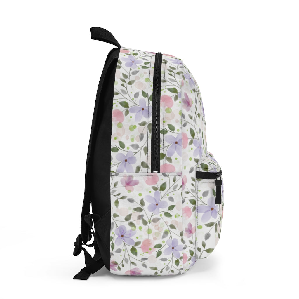 side view of the pink, purple and green flower and leaves pattern backpack