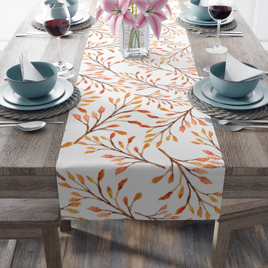 fall leaves table runner with orange, yellow and brown leaves.