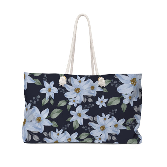 farmhouse overnight bag with blue flowers in navy blue background 