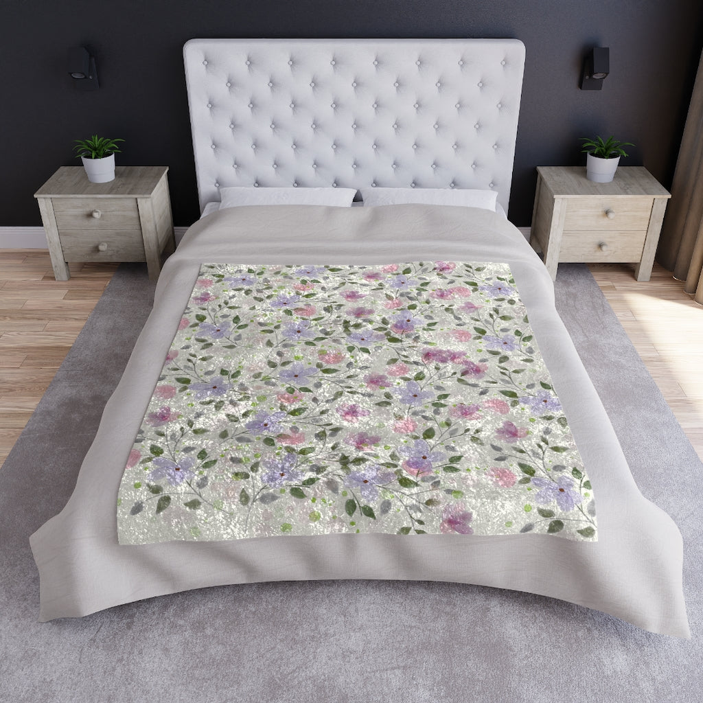 floral blanket displayed on a bed