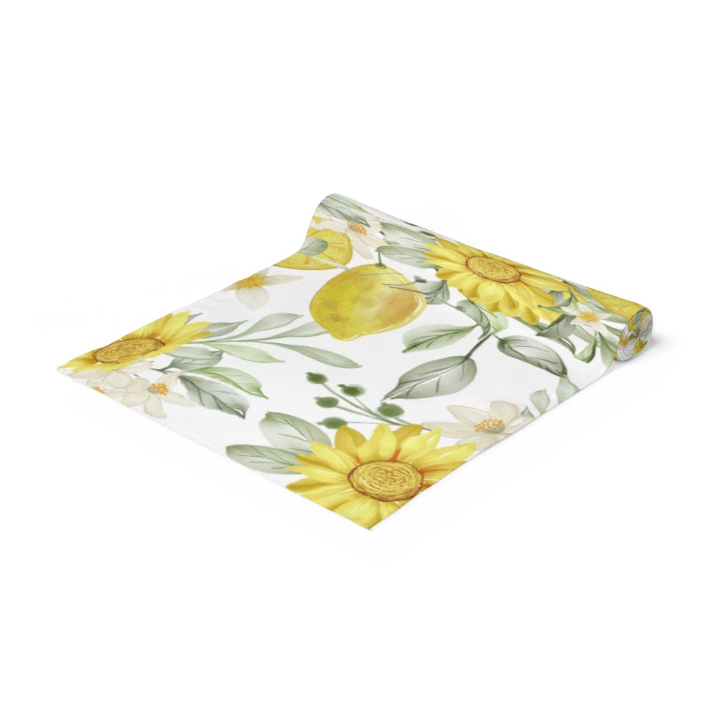 lemon table decor featuring a yellow and white table runner with sunflowers and lemons 