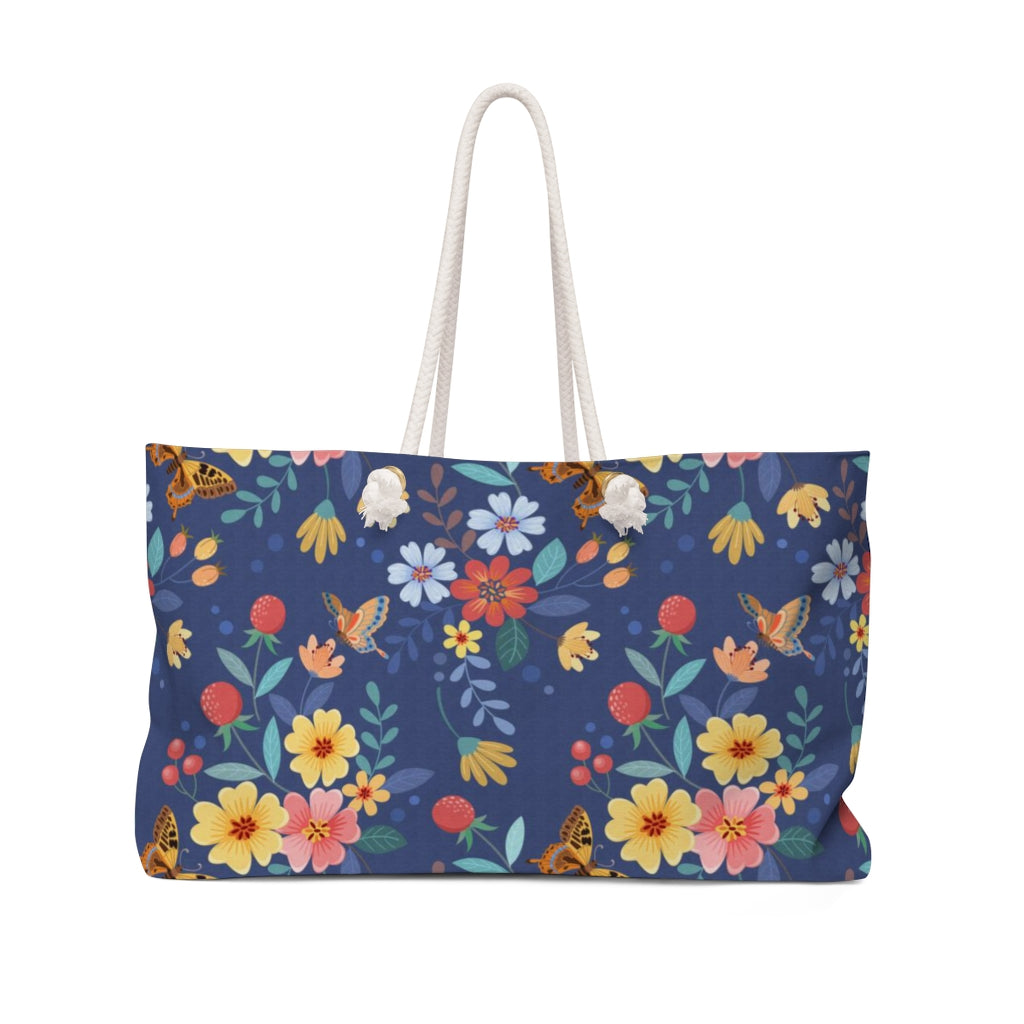 farmhouse floral weekender bag in blue with yellow, pink and orange flowers and butterflies 