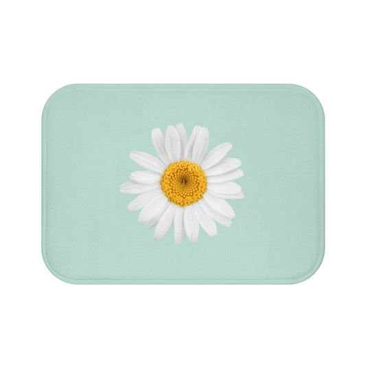blue bath mat with one daisy in the middle