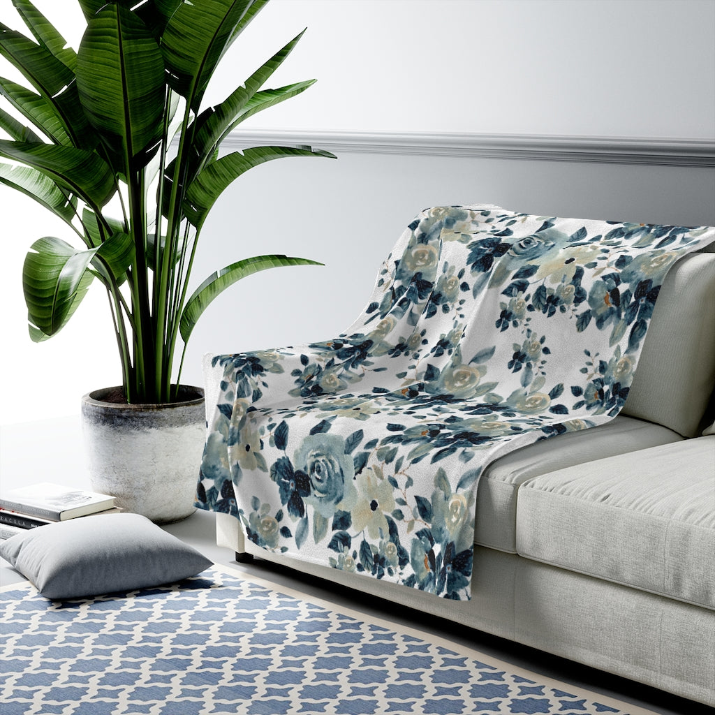 blue floral blanket with white backgrond. grey accents with blue flowers 