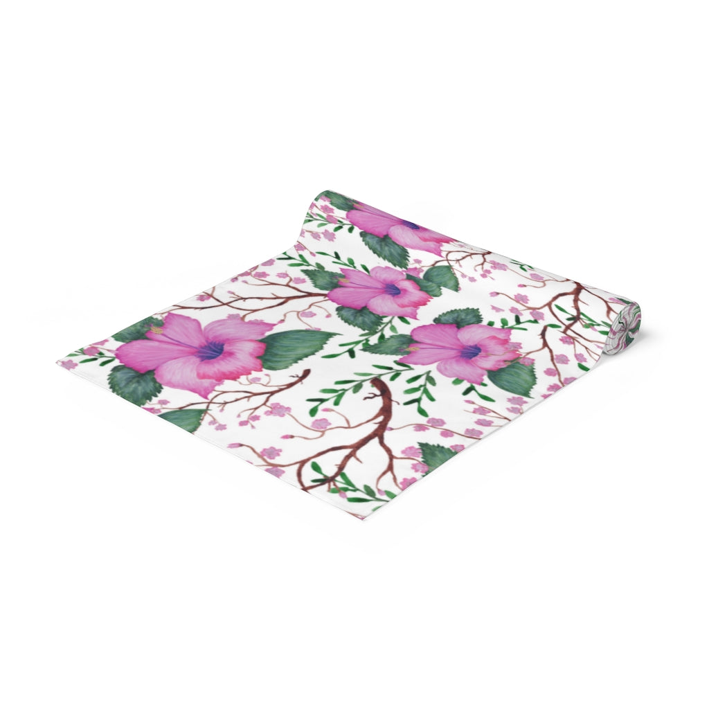 pink floral table runner with green leaves and vines 