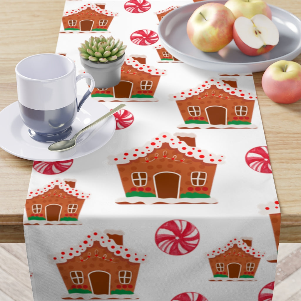 gingerbread house table runner with christmas candy and gingerbread house pattern on a white background 