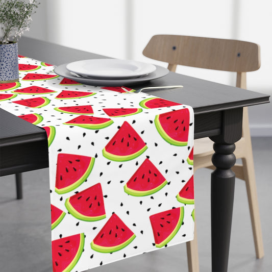 watermelon table runner with pieces of watermeon and seeds on a white background