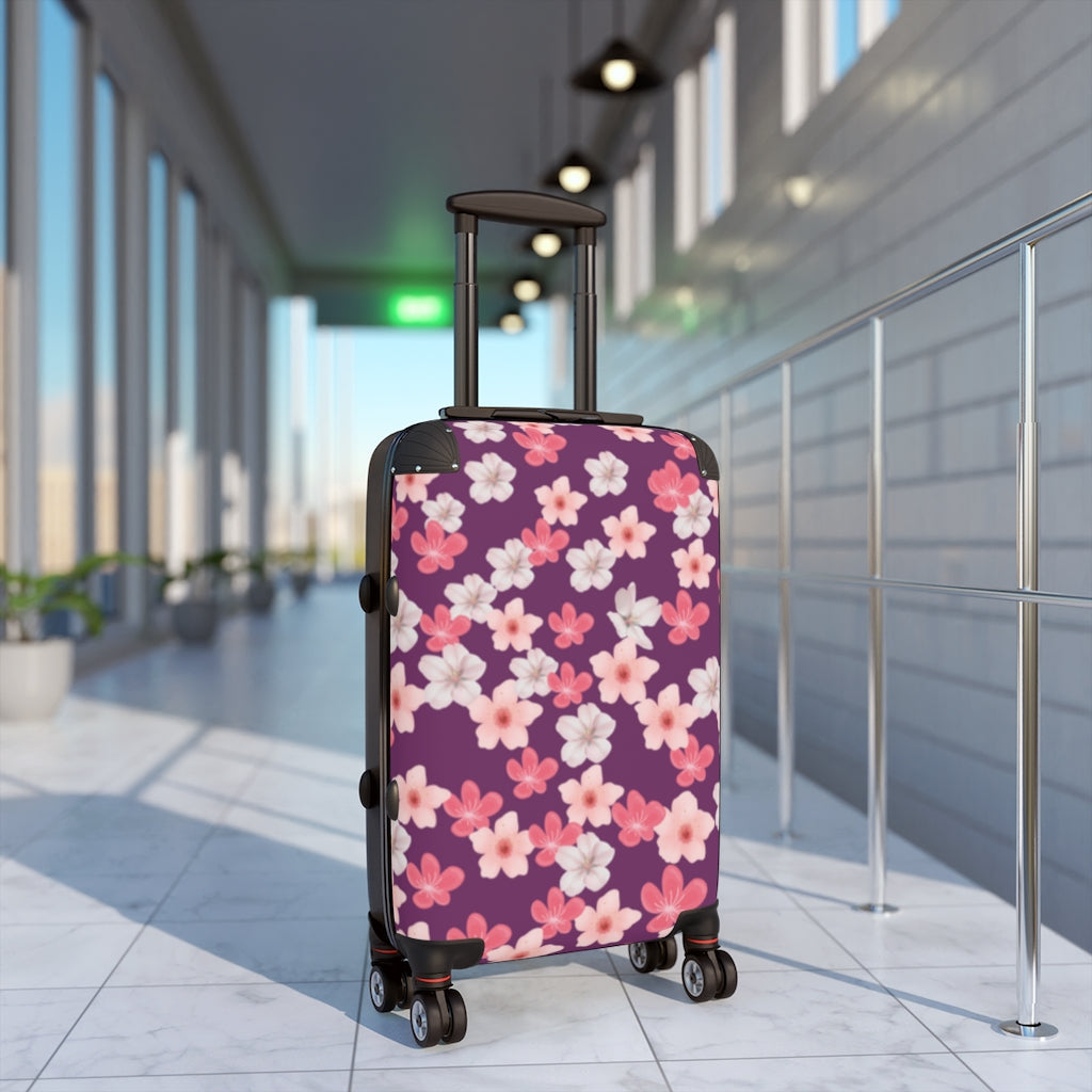 purple suitcase with cherry blossom flowers in pink and white flowers