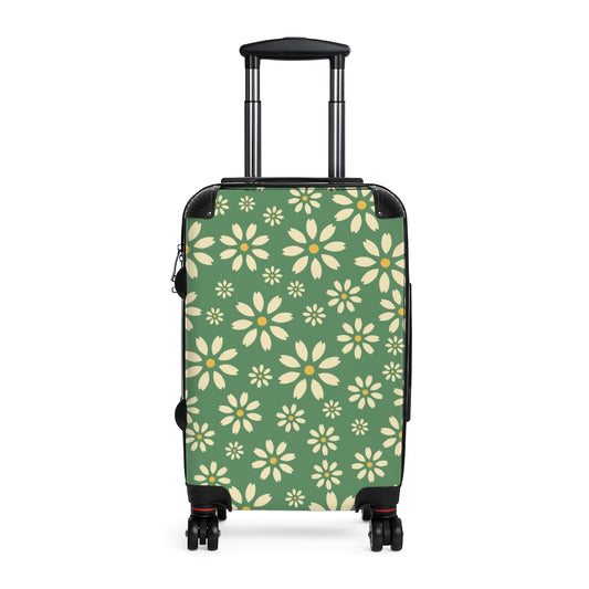 green suitcase with white daisy pattern