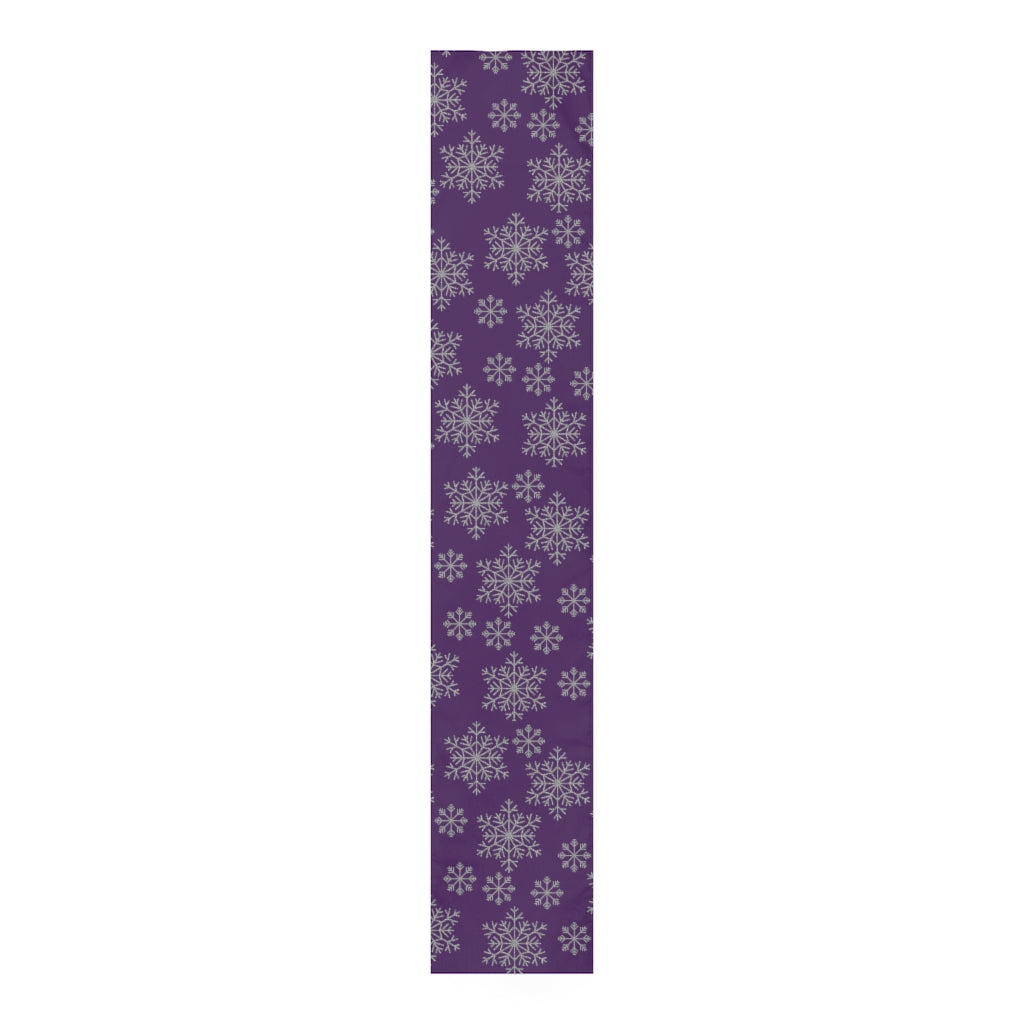flat view of purple table runner with silver snowflakes for christmas table decor