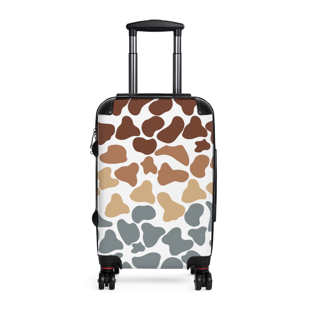 brown, beige and blue cow print suitcase