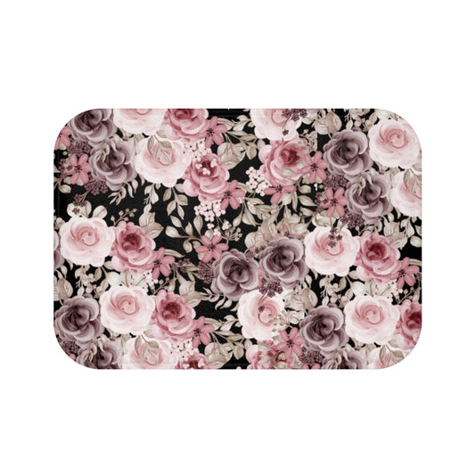 floral bath mat with pink and purple rose pattern on a black background