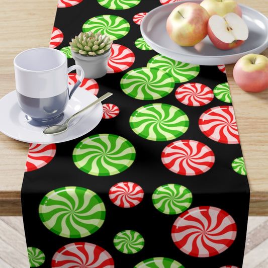 black christmas table runner with red and green christmas candy pattern