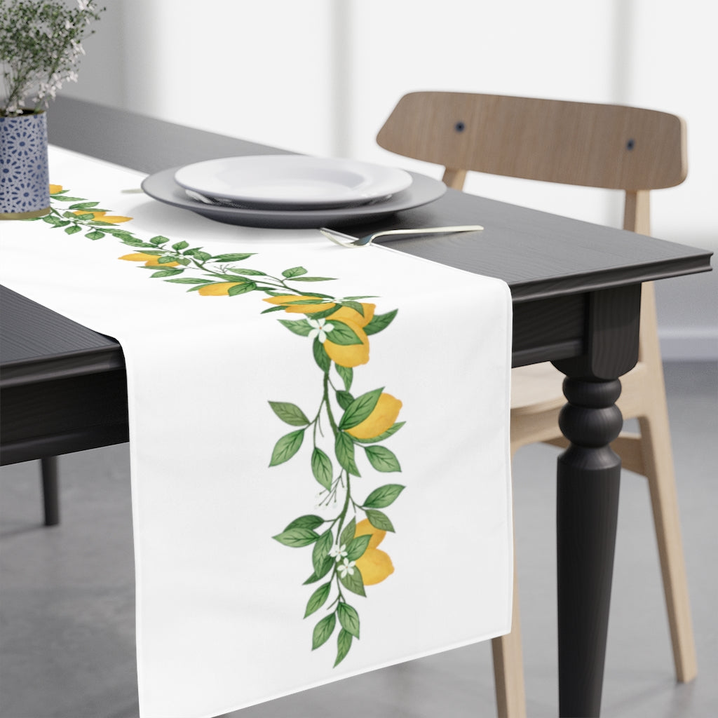 lemon table runner with lemons and green leaves