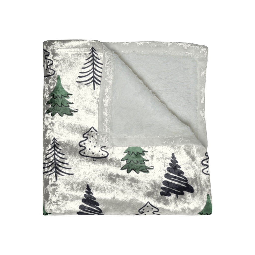 folded view of the minimalist tree blanket in navy blue and green trees