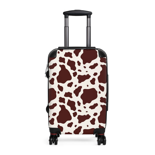 brown and white cow print luggage featuring a cabin suitcase