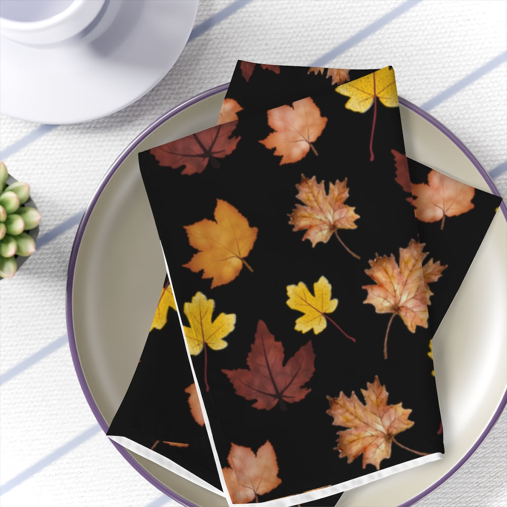 fall napkins with changing leaves pattern in yellow, orange, red and brown leaves.