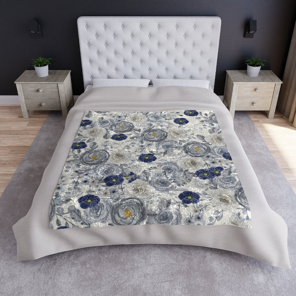 blue rose flower blanket displayed on a bed